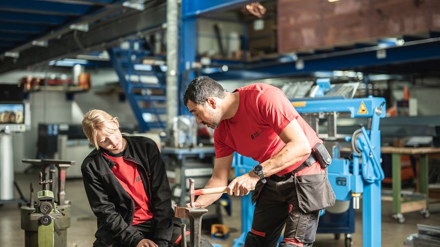 Felicia und James bei Spenglerarbeiten in der Werkstatt.